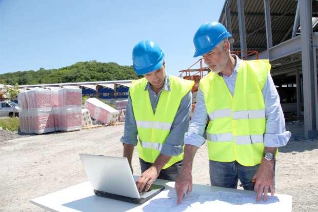 construction workers with laptop