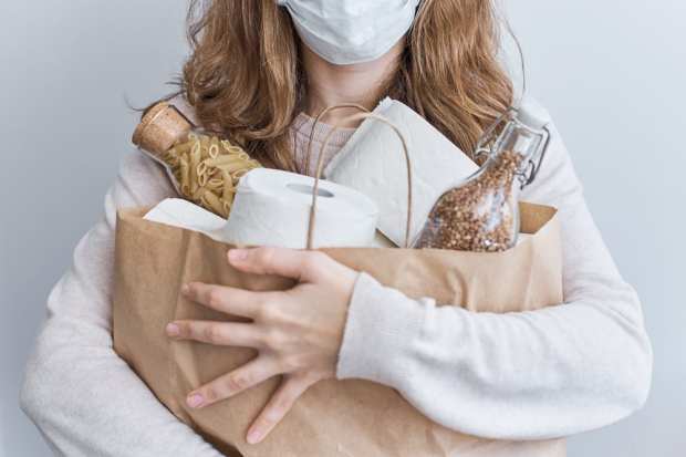 consumer with groceries and mask