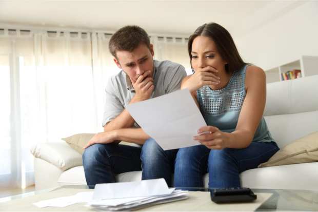 worried couple with bills