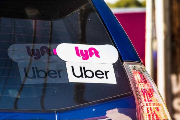 Lyft and Uber stickers on car