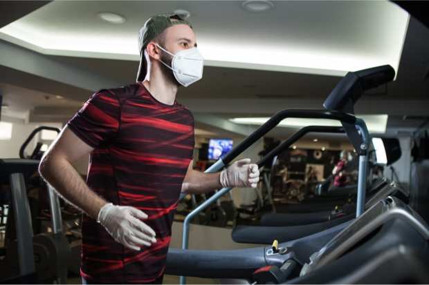 man in gym with face mask