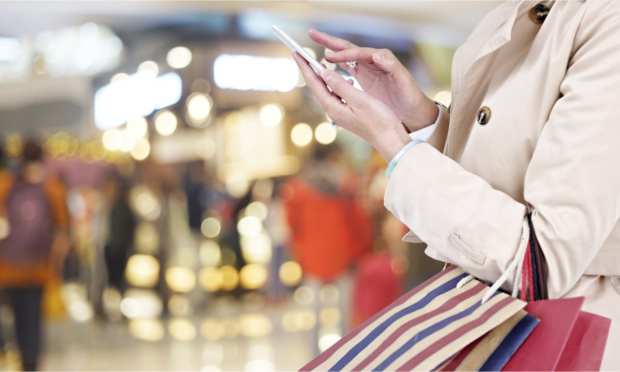 shopper with smartphone in mall
