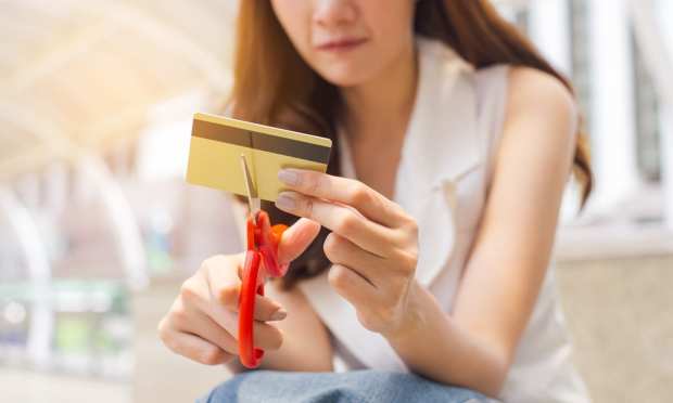 woman cutting up credit card