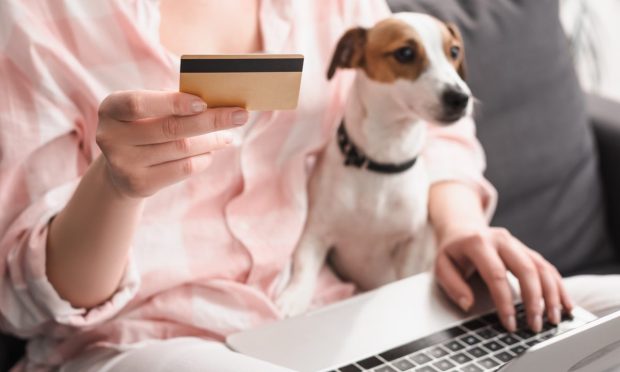woman with credit card and dog