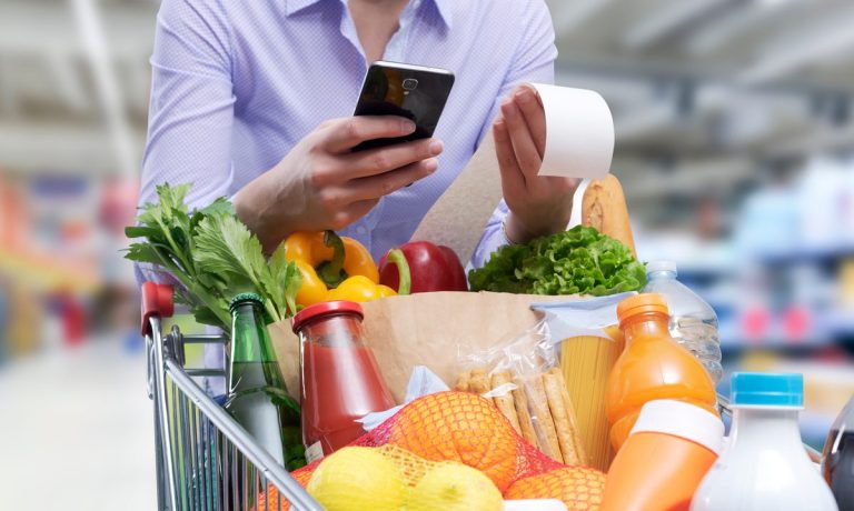 woman checking grocery receipt