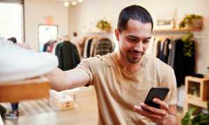 man in store using smartphone