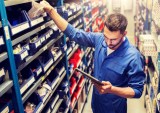 man checking shelves in car parts store
