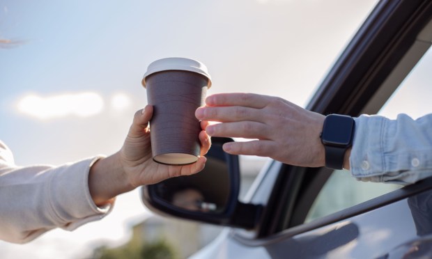coffee cup being handed to driver