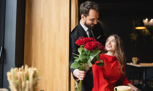 man giving roses to woman
