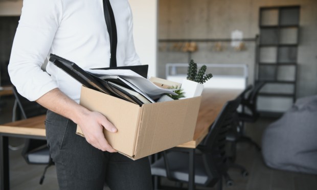 laid-off employee leaving office with box