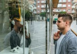 man looking in store window