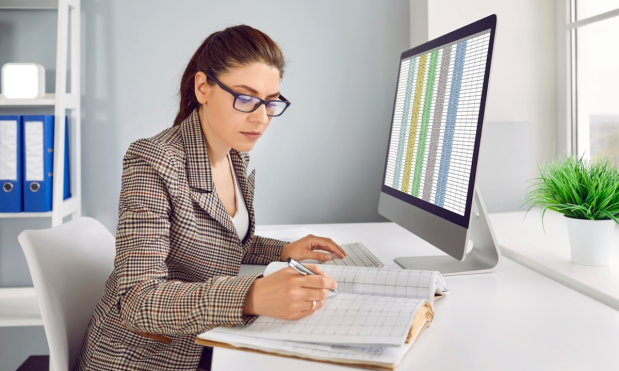 office worker with spreadsheet on computer