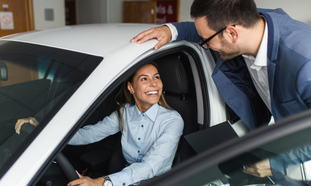 young woman buying new car