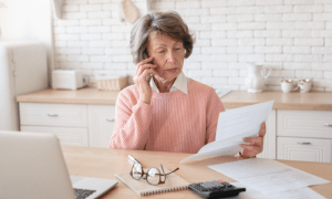 woman on phone with bills