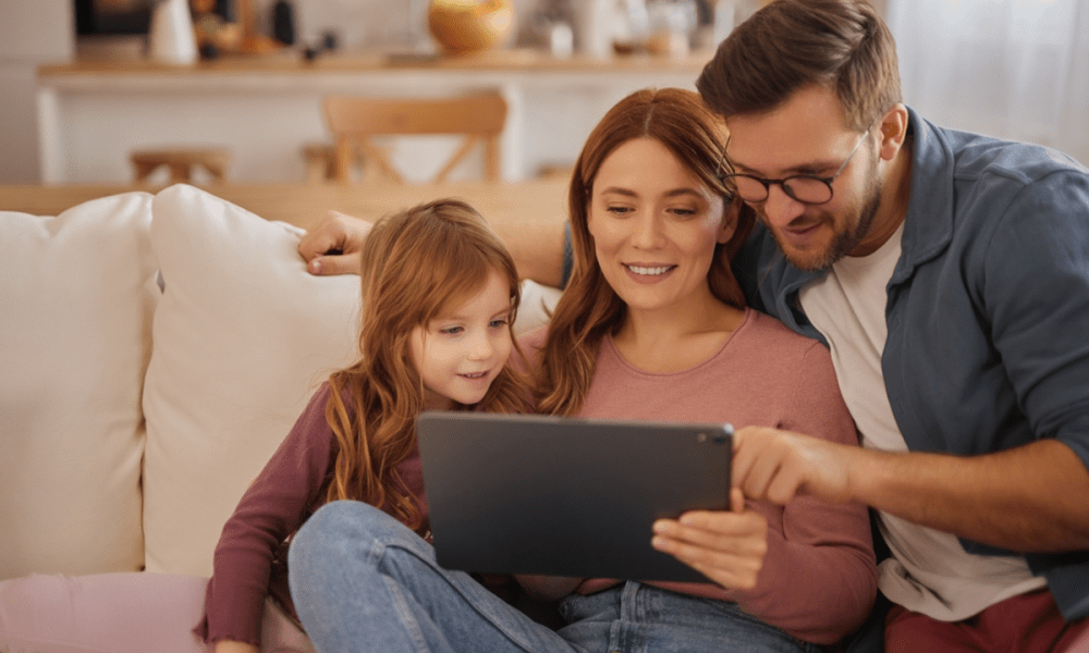 family looking at digital tablet