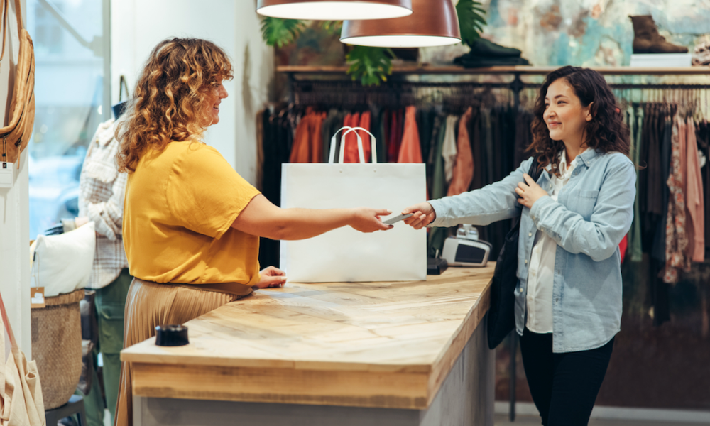 woman paying in clothing store