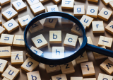 letter tiles and magnifying glass