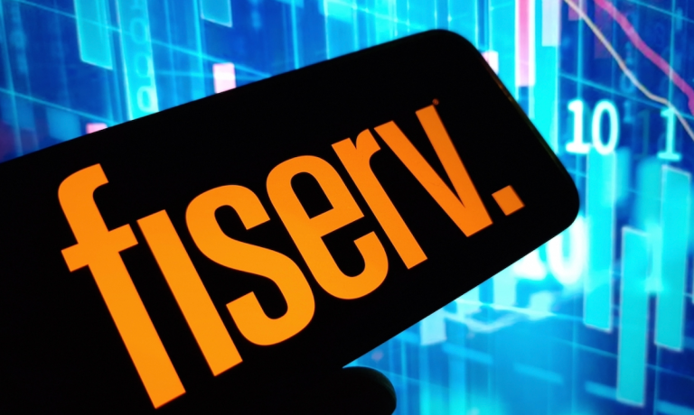 Fiserv on phone with stock charts behind