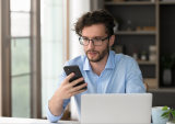 man with laptop and phone