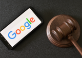 Google logo on phone next to gavel