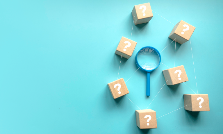 question marks and magnifying glass