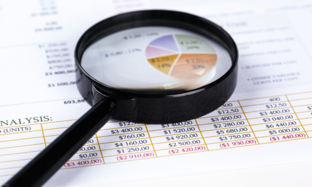magnifying glass on financial charts