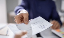 person handing over a check
