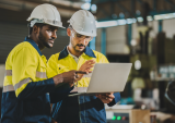 Two industrial workers with laptop