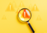 magnifying glass and warning signs