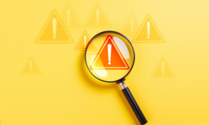 magnifying glass and warning signs