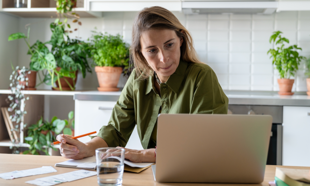 woman with laptop and papers