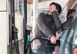man pumping gas into car