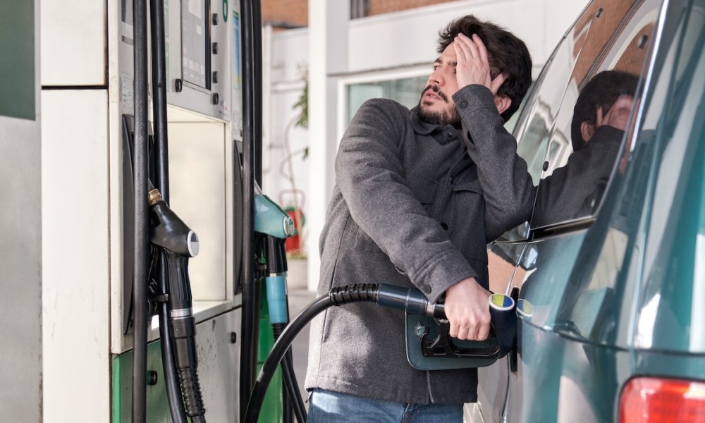man pumping gas into car