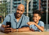 man and child with phone