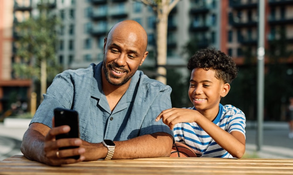 man and child with phone