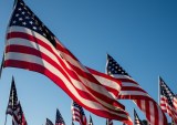 American flags against blue sky