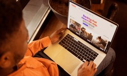 man with laptop on Happen website
