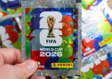 Hand holding Panini FIFA World Cup 2026 trading card sticker packs, foil booster packets for football soccer tournament collectors