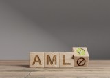 Wood cubes with acronym 'AML' - 'Anti Money Laundering' on a wooden table