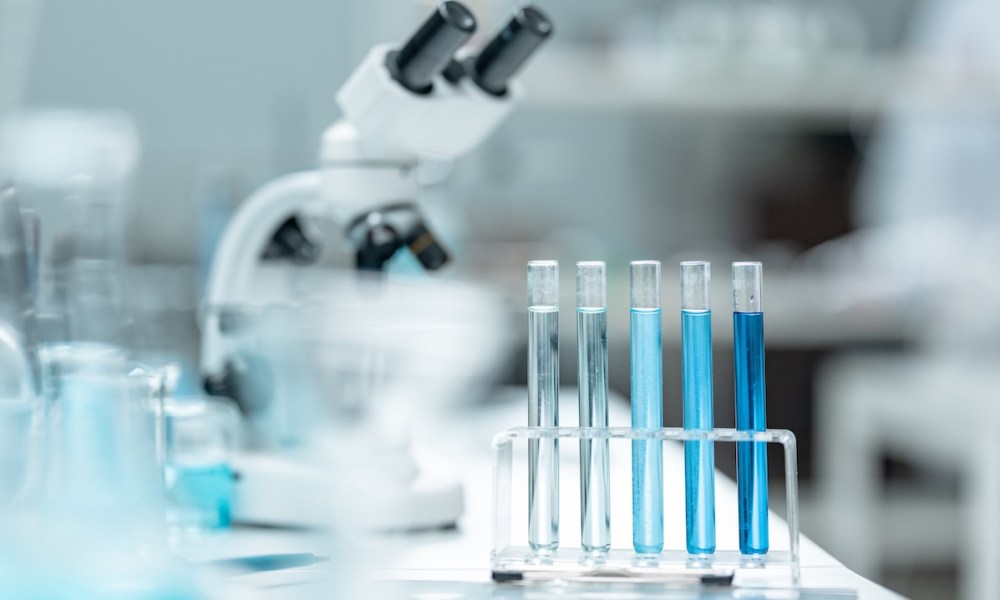 Chemical laboratory glassware with blue liquid samples in test tubes