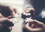 Hand holding jigsaw puzzles, Business partnership concept.
