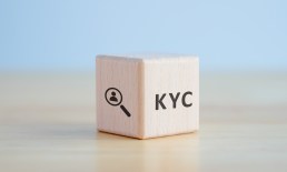 KYC on wooden cubes. know your customer with magnifying glass. Business verifying the identity of its clients concept