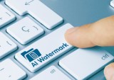 AI Watermark Written on Blue Key of Metallic Keyboard. Finger pressing key.