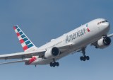 American Airlines plane flying in blue sky
