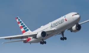 American Airlines plane flying in blue sky